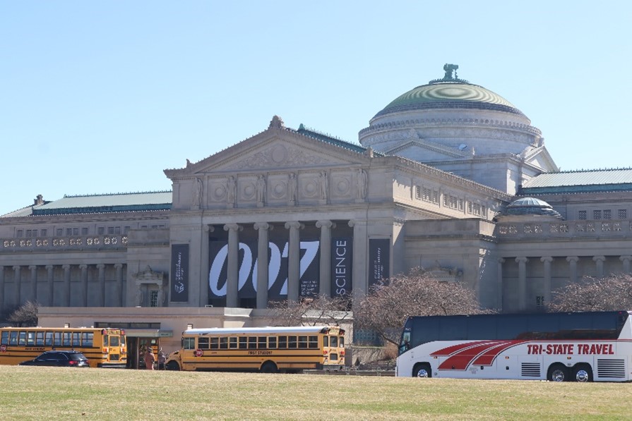The outside of the Museum of Science and Industry in Chicago with a sign for 007 Science
